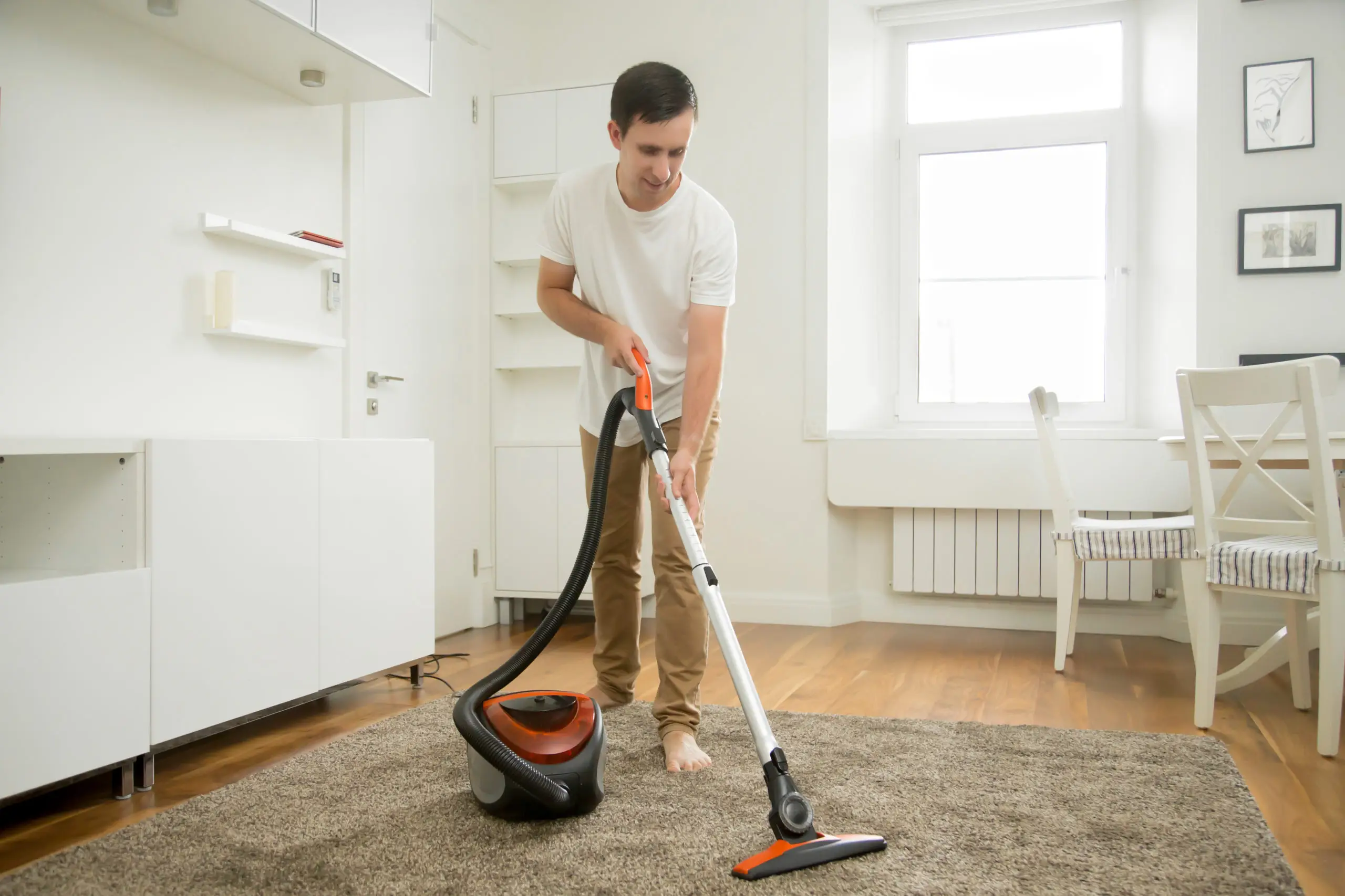 happy-smiling-man-cleaning-carpet-scaled